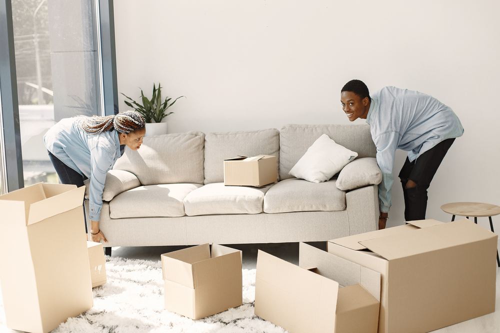 People moving boxes into a new home